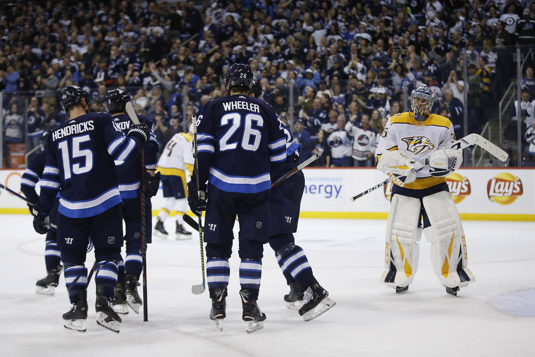 Winnipeg Jets celebrate Andrew Copp's (9) goal as Nashville Predators goaltender Pekka Rinne (35) look on during the second period of an NHL hockey game, Saturday, March 23, 2019 in Winnipeg, Mani ...