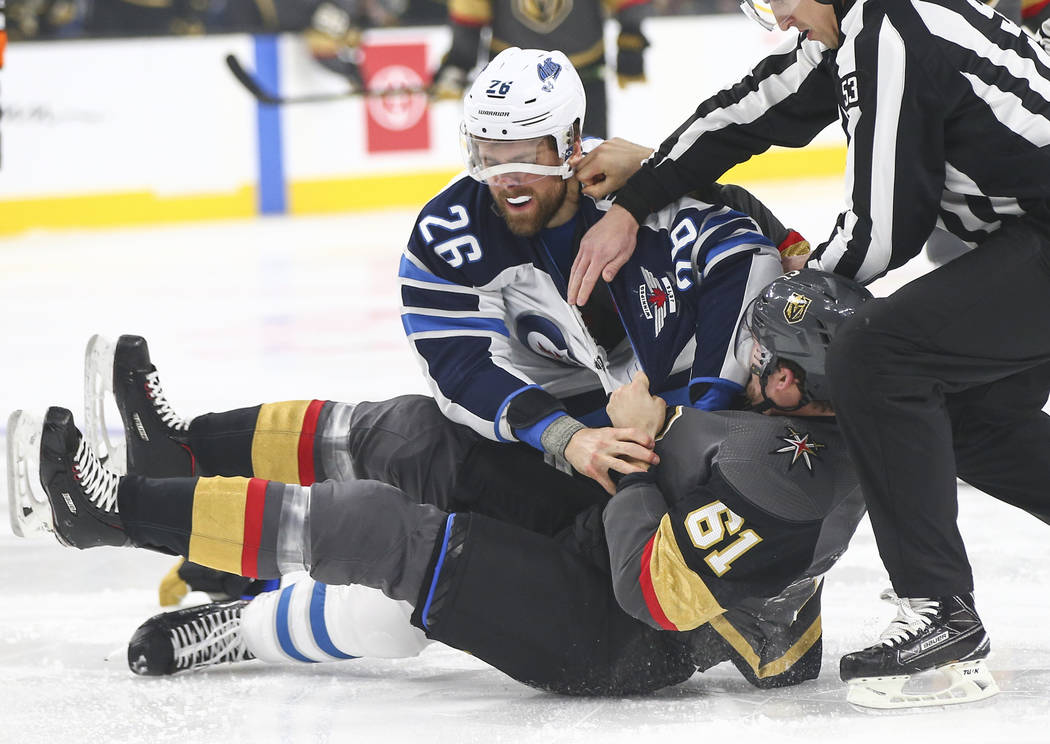 Winnipeg Jets right wing Blake Wheeler (26) fights Golden Knights right wing Mark Stone (61) during the first period of an NHL hockey game at T-Mobile Arena in Las Vegas on Thursday, March 21, 201 ...