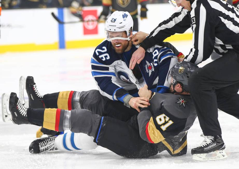 Winnipeg Jets right wing Blake Wheeler (26) fights Golden Knights right wing Mark Stone (61) during the first period of an NHL hockey game at T-Mobile Arena in Las Vegas on Thursday, March 21, 201 ...