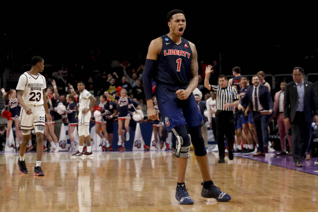 Liberty guard Caleb Homesley celebrates after scoring against Mississippi State during the second half of a first-round game in the NCAA men's college basketball tournament Friday, March 22, 2019, ...