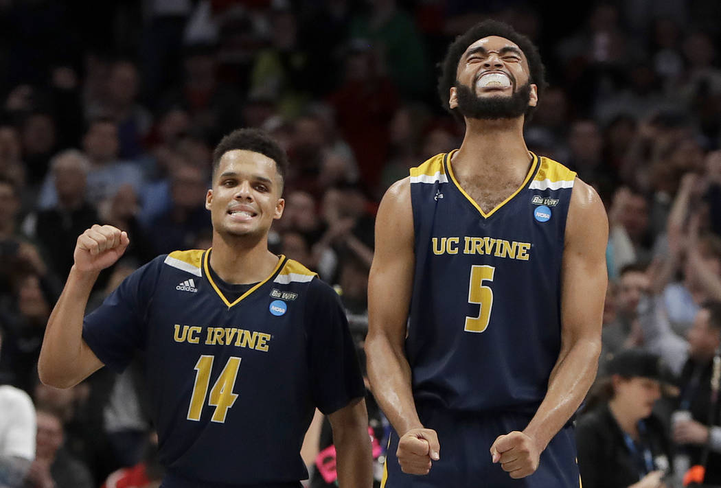UC Irvine guard Evan Leonard (14) and forward Jonathan Galloway (5) celebrate after they defeated Kansas State in a first round men's college basketball game in the NCAA Tournament, Friday, March ...