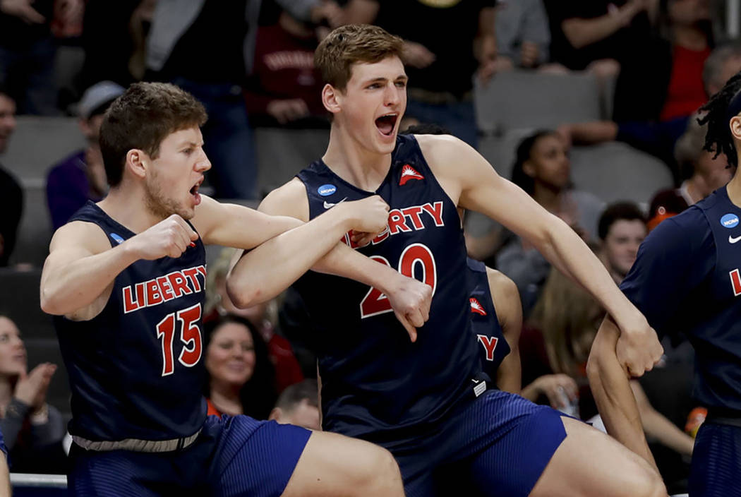 Liberty's Zach Farquhar, left, and Keegan McDowell celebrate during the second half of a first round men's college basketball game against Mississippi State in the NCAA tournament Friday, March 22 ...