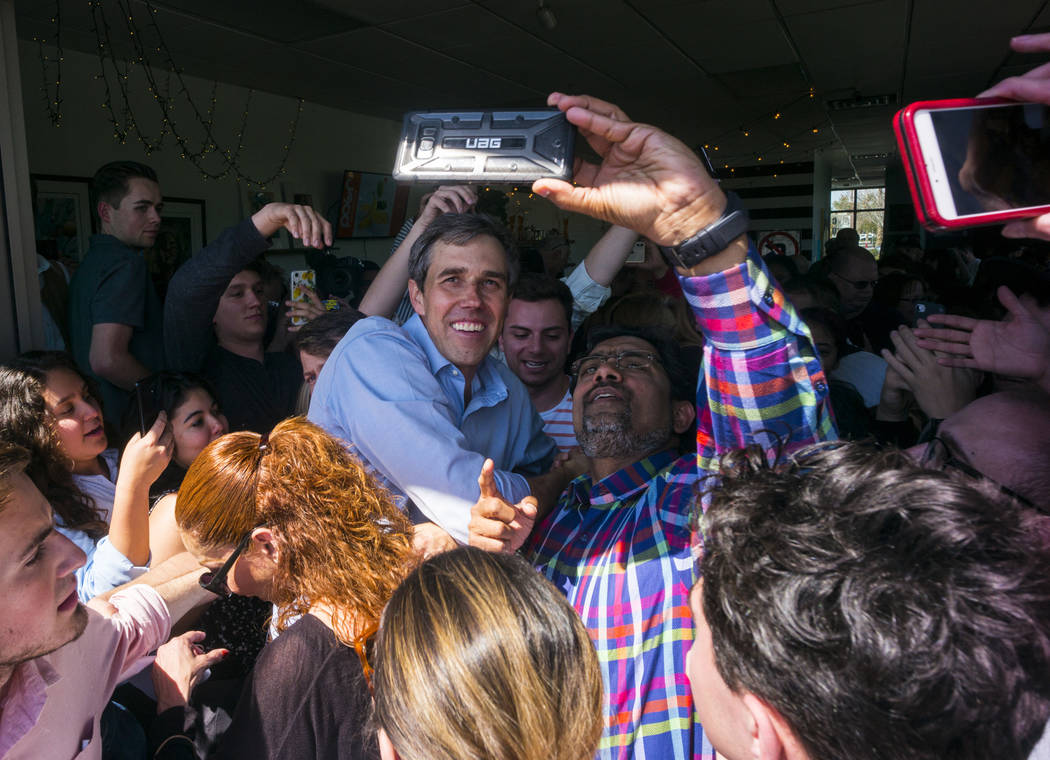 Democratic presidential candidate and former Texas congressman Beto O'Rourke takes pictures with supporters during a campaign stop at Pour Coffeehouse in Las Vegas on Sunday, March 24, 2019. (Chas ...