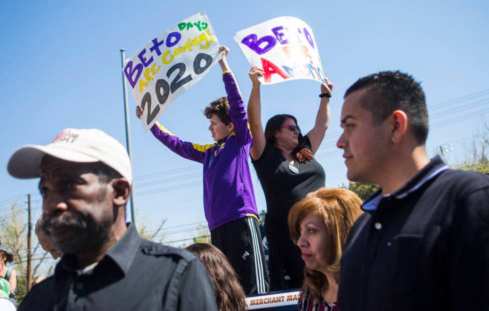 Gabriel Shimel, 11, left, and Angela Shimel hold up signs in support of Democratic presidential candidate and former Texas congressman Beto O'Rourke before he arrived for a campaign event at Pour ...