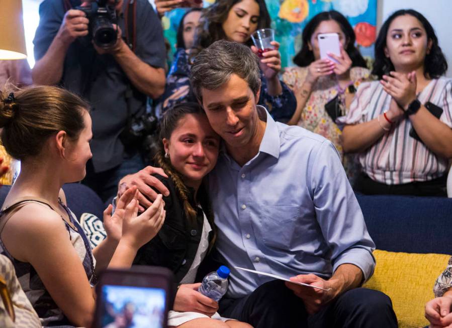 Eleven-year-old Karola Garcia is comforted by Democratic presidential candidate and former Texas congressman Beto O'Rourke at a meet and greet event with the Mujeres Network in west Las Vegas on S ...