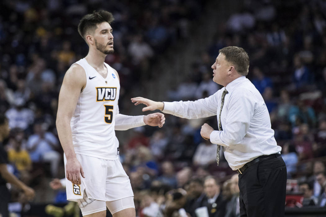 VCU head coach Mike Rhoades, right, talks with forward Sean Mobley (5) during the first half of a first-round game in the NCAA men's college basketball tournament Friday, March 22, 2019, in Columb ...