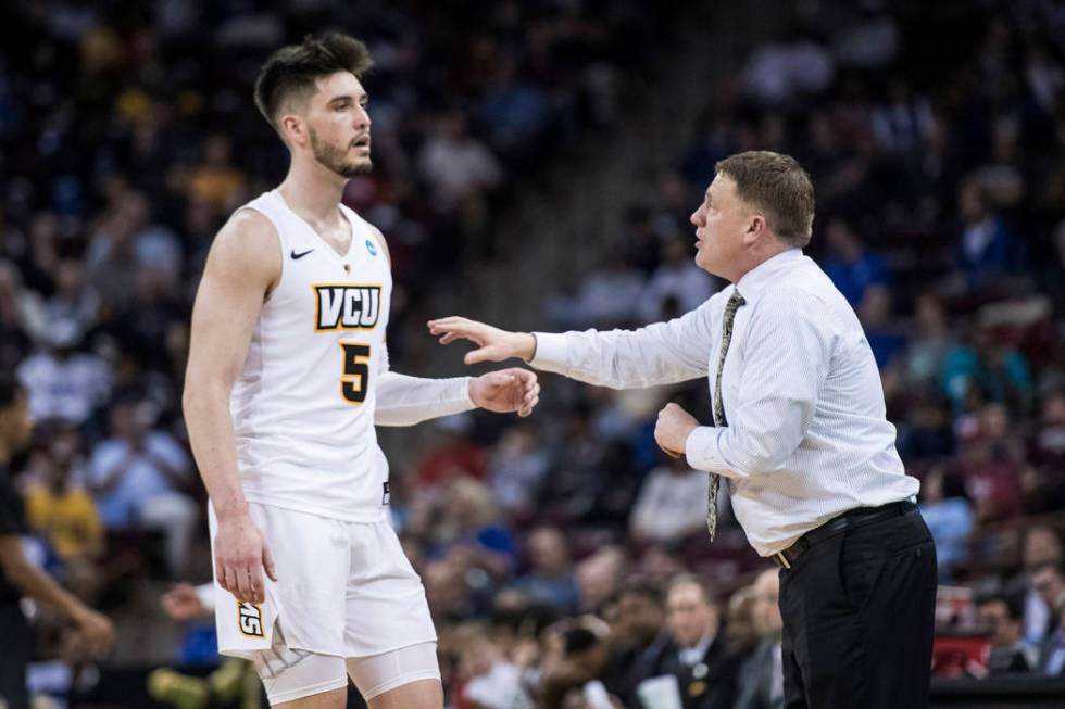 VCU head coach Mike Rhoades, right, talks with forward Sean Mobley (5) during the first half of a first-round game in the NCAA men's college basketball tournament Friday, March 22, 2019, in Columb ...