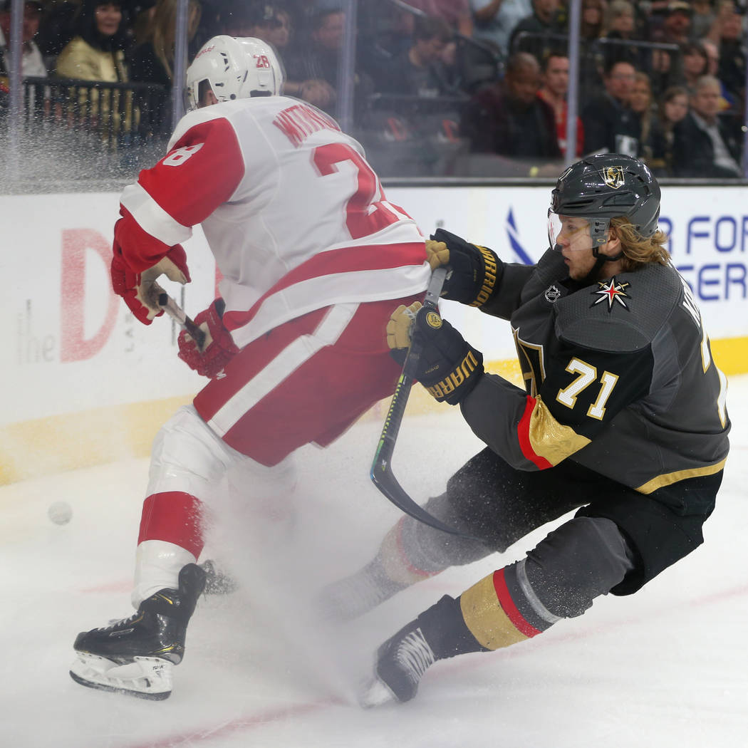 Vegas Golden Knights center William Karlsson (71) fights for the puck against Detroit Red Wings right wing Luke Witkowski (28) during the first period of an NHL hockey game at T-Mobile Arena in La ...