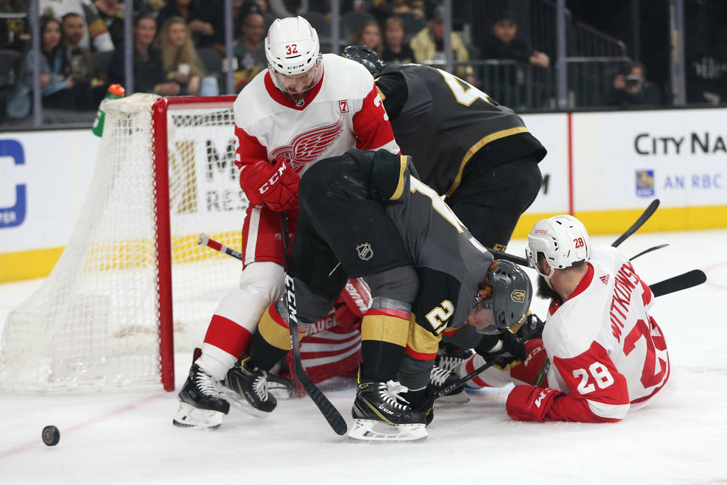 Vegas Golden Knights center Cody Eakin (21) fights for the puck against Detroit Red Wings defenseman Brian Lashoff (32) during the first period of an NHL hockey game at T-Mobile Arena in Las Vegas ...