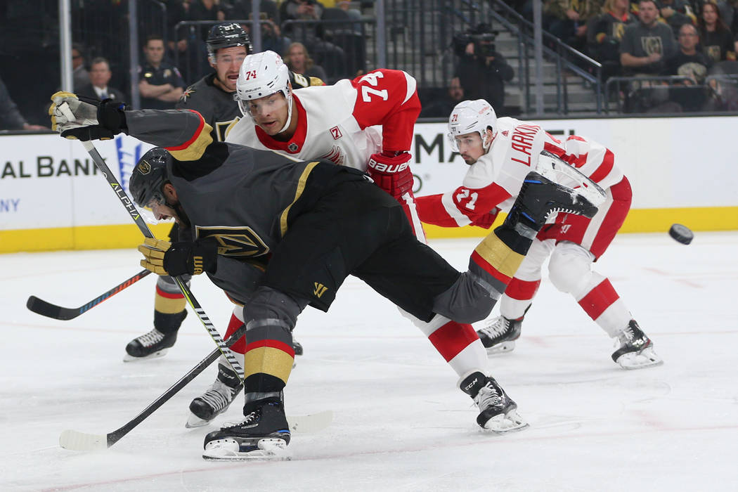 Vegas Golden Knights right wing Alex Tuch (89) loses the puck against Detroit Red Wings defenseman Madison Bowey (74) during the first period of an NHL hockey game at T-Mobile Arena in Las Vegas, ...