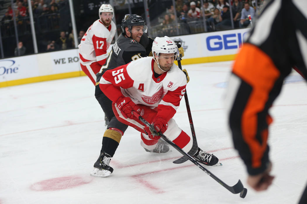 Vegas Golden Knights center Jonathan Marchessault (81) goes for a loose puck against Detroit Red Wings defenseman Niklas Kronwall (55) during the second period of an NHL hockey game at T-Mobile A ...