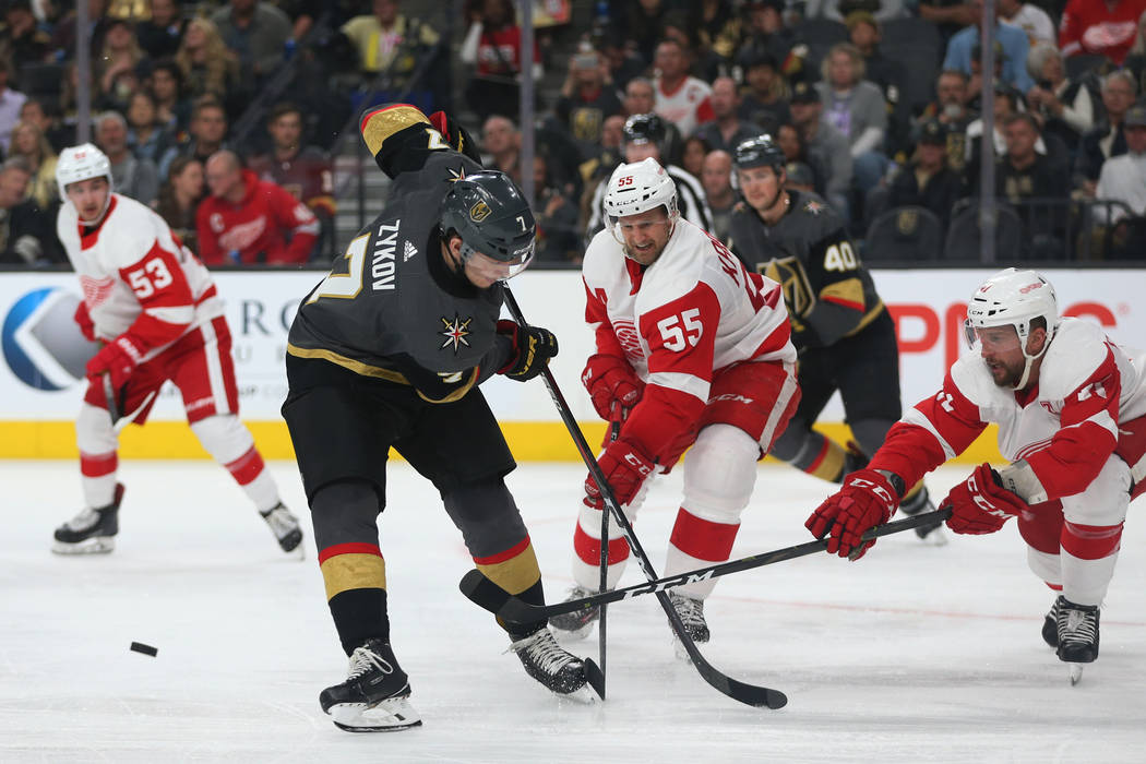 Vegas Golden Knights left wing Valentin Zykov (7) goes for the puck against Detroit Red Wings defenseman Niklas Kronwall (55) and center Luke Glendening (41) during the second period of an NHL hoc ...