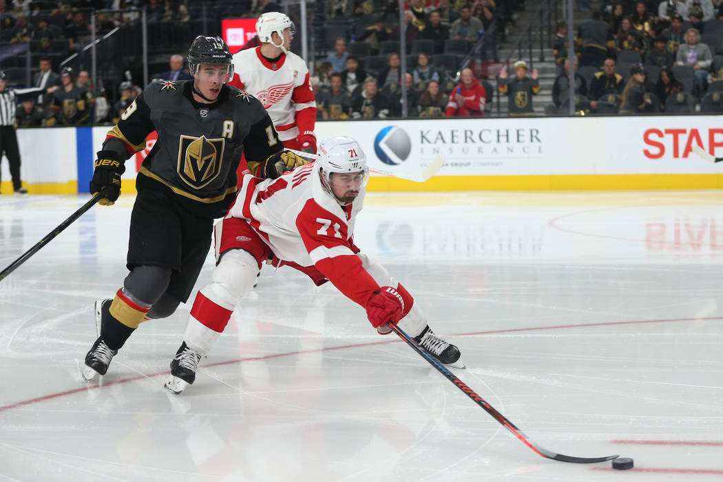 Vegas Golden Knights right wing Reilly Smith (19) goes for the puck against Detroit Red Wings center Dylan Larkin (71) during the second period of an NHL hockey game at T-Mobile Arena in Las Vegas ...