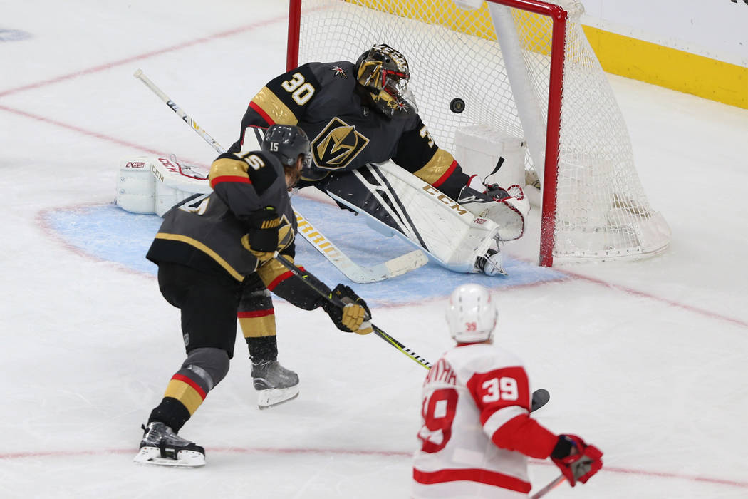 Detroit Red Wings right wing Anthony Mantha (39) shoots for a score against Vegas Golden Knights goaltender Malcolm Subban (30) and defenseman Jon Merrill (15) during the third period of an NHL ho ...