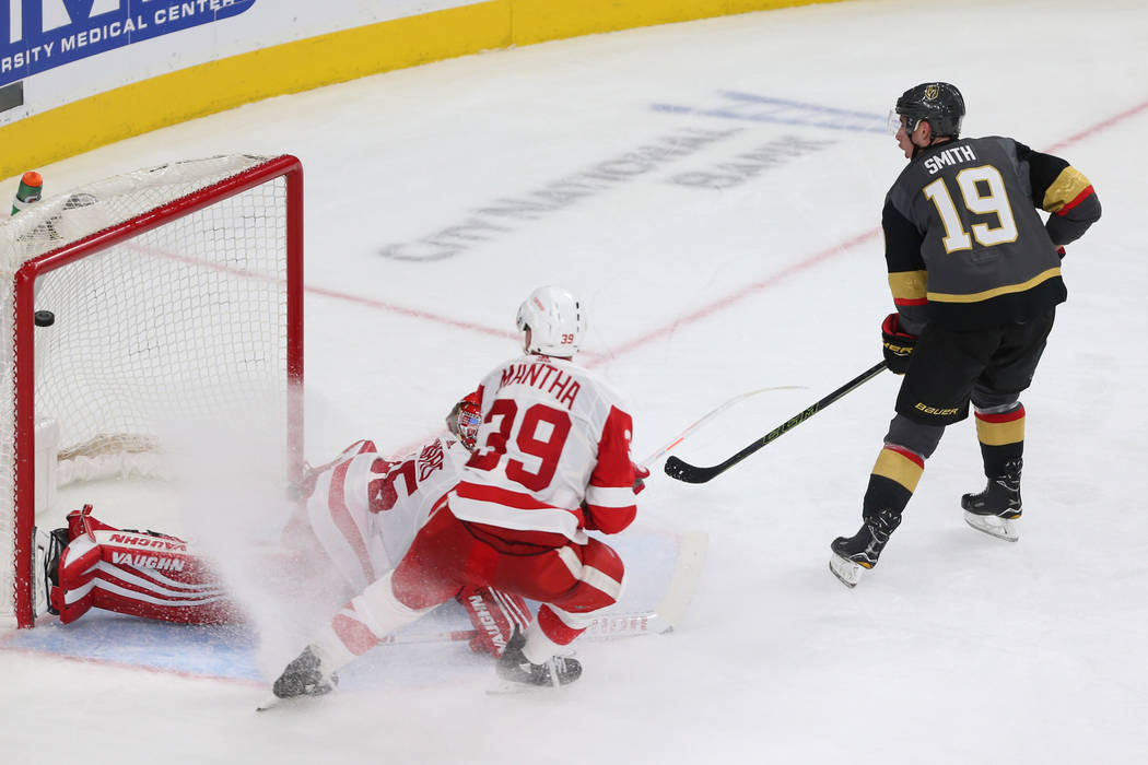 Vegas Golden Knights right wing Reilly Smith (19) shoots for a score against Detroit Red Wings goaltender Jimmy Howard (35) and right wing Anthony Mantha (39) during the third period of an NHL hoc ...