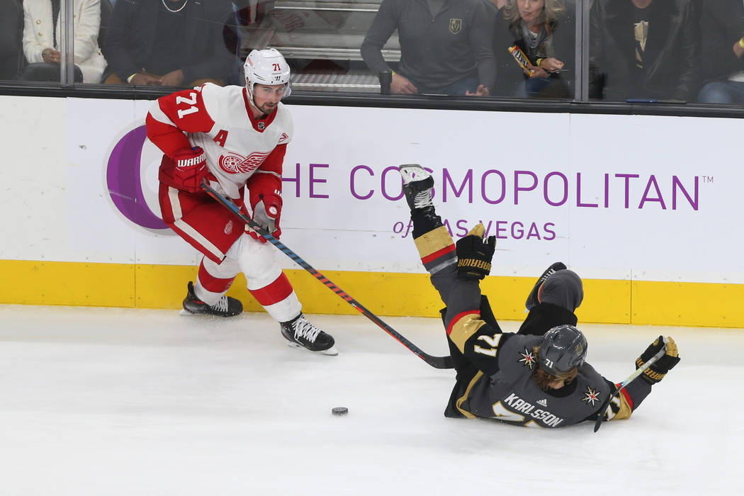 Detroit Red Wings center Dylan Larkin (71) trips Vegas Golden Knights center William Karlsson (71) during the third period of an NHL hockey game at T-Mobile Arena in Las Vegas, Saturday, March 23, ...