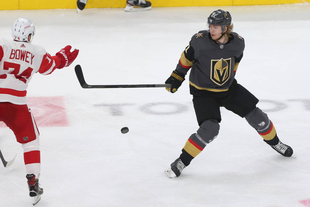Vegas Golden Knights center William Karlsson (71) goes for the puck against Detroit Red Wings defenseman Madison Bowey (74) during the third period of an NHL hockey game at T-Mobile Arena in Las V ...