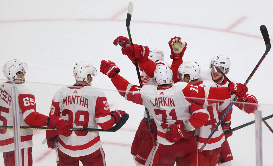 Detroit Red Wings right wing Anthony Mantha (39) celebrates the winning goal with the assist by center Dylan Larkin (71) during overtime of an NHL hockey game at T-Mobile Arena in Las Vegas, Satur ...