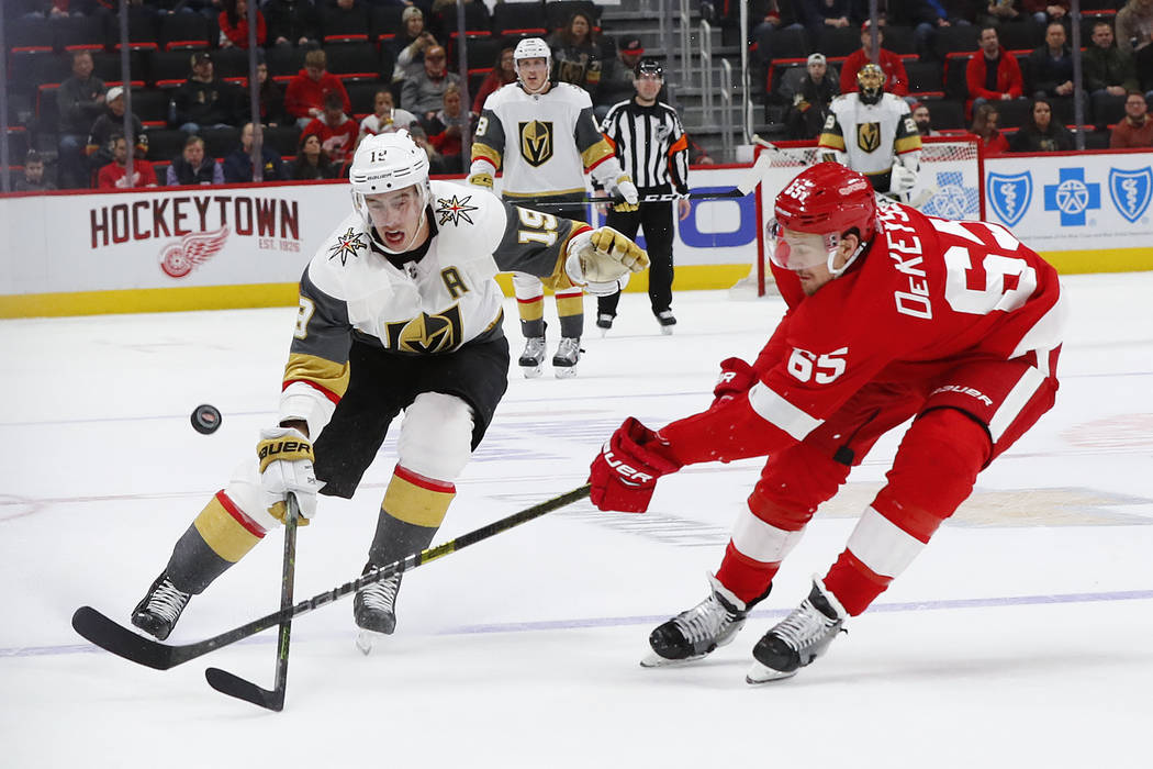 Detroit Red Wings defenseman Danny DeKeyser (65) knocks the puck away from Vegas Golden Knights right wing Reilly Smith (19) in the third period of an NHL hockey game Thursday, Feb. 7, 2019, in De ...