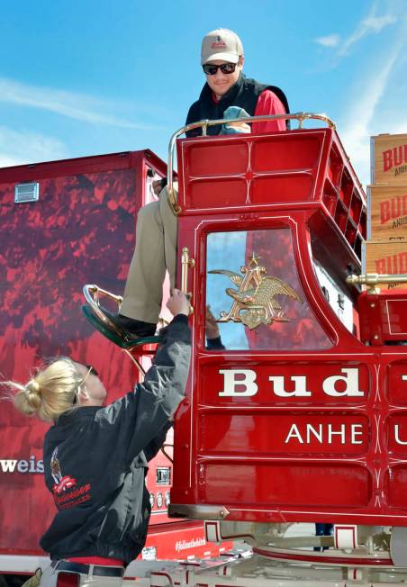 Handlers Lauren Lambeth, left, and Andrew LaCrosse polish the brass on the beer wagon during a visit by the Budweiser Clydesdales to the Smith’s Marketplace at 9710 W. Skye Canyon Park Driv ...