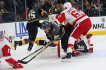 Vegas Golden Knights left wing William Carrier (28) is taken down by Detroit Red Wings defenseman Danny DeKeyser (65) during the first period of an NHL hockey game at T-Mobile Arena in Las Vegas, ...