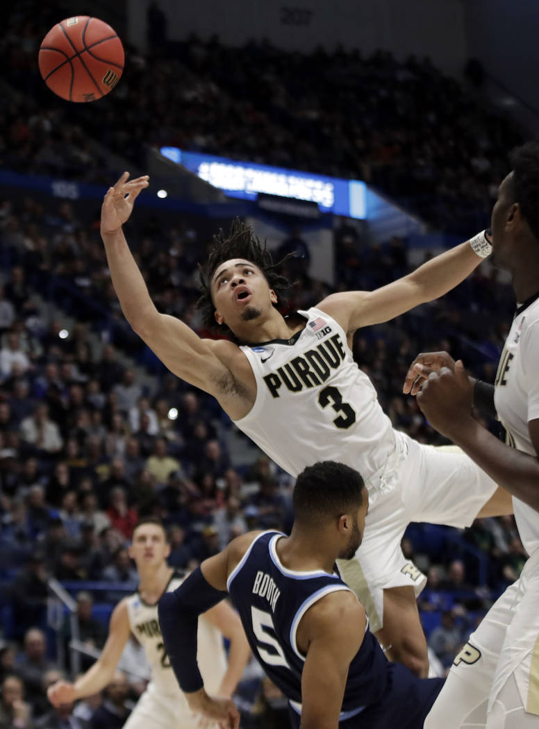 Purdue's Carsen Edwards (3) drives and is fouled by Villanova's Phil Booth (5) during the first half of a second round men's college basketball game in the NCAA Tournament, Saturday, March 23, 201 ...