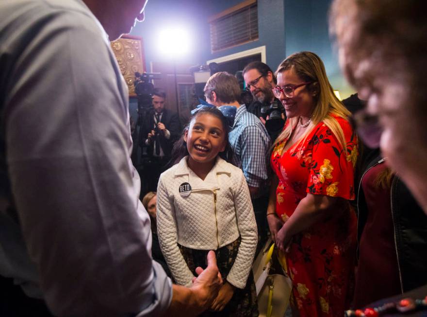 Nine-year-old Mia Mendez talks with Democratic presidential candidate and former Texas congressman Beto O'Rourke during a campaign stop at a home in the Summerlin area of Las Vegas on Saturday, Ma ...