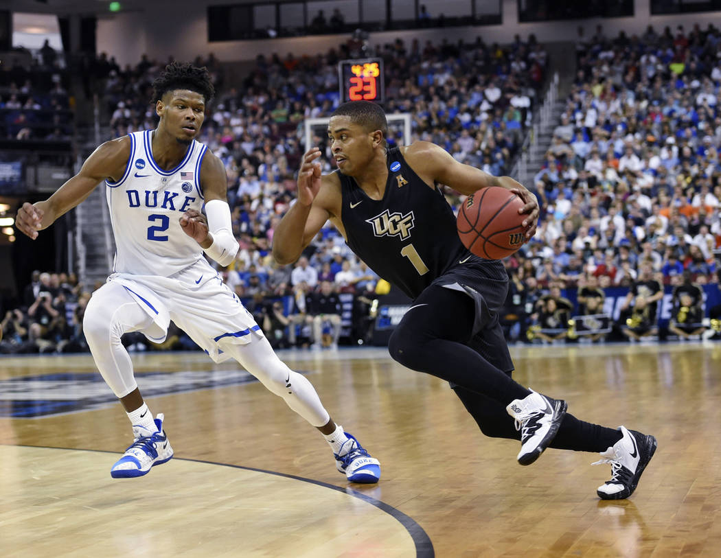 Central Florida's BJ Taylor (1) drives down the baseline while defended by Duke's Cam Reddish (2) during the first half of a first round men's college basketball game in the NCAA Tournament in Col ...