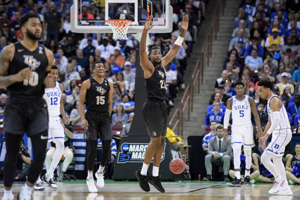 Central Florida forward Chad Brown (21) celebrates after a dunk against Duke during the first half of a second-round game in the NCAA men's college basketball tournament Sunday, March 24, 2019, in ...