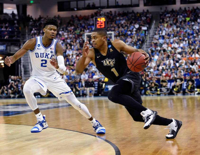 Central Florida's BJ Taylor (1) drives down the baseline while defended by Duke's Cam Reddish (2) during the first half of a first round men's college basketball game in the NCAA Tournament in Col ...