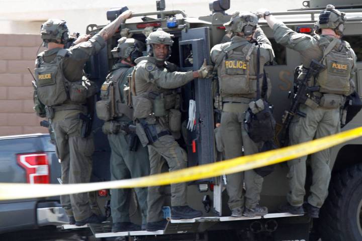 A SWAT vehicle carries a Metropolitan Police Department SWAT team during a barricade situation near Grand Teton and Durango in the northwest area of the Las Vegas valley, Saturday, March 23, 2019. ...