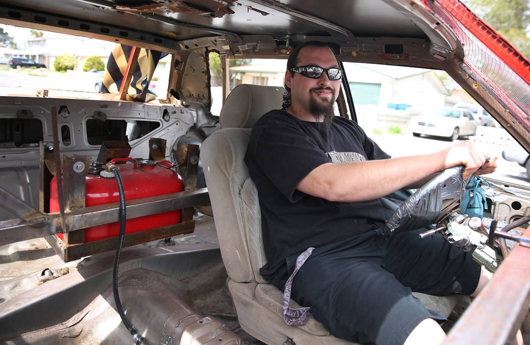 Andrew Carmean, a demolition driver, poses for a photo inside his 1988 Lincoln Town Car on Tues ...