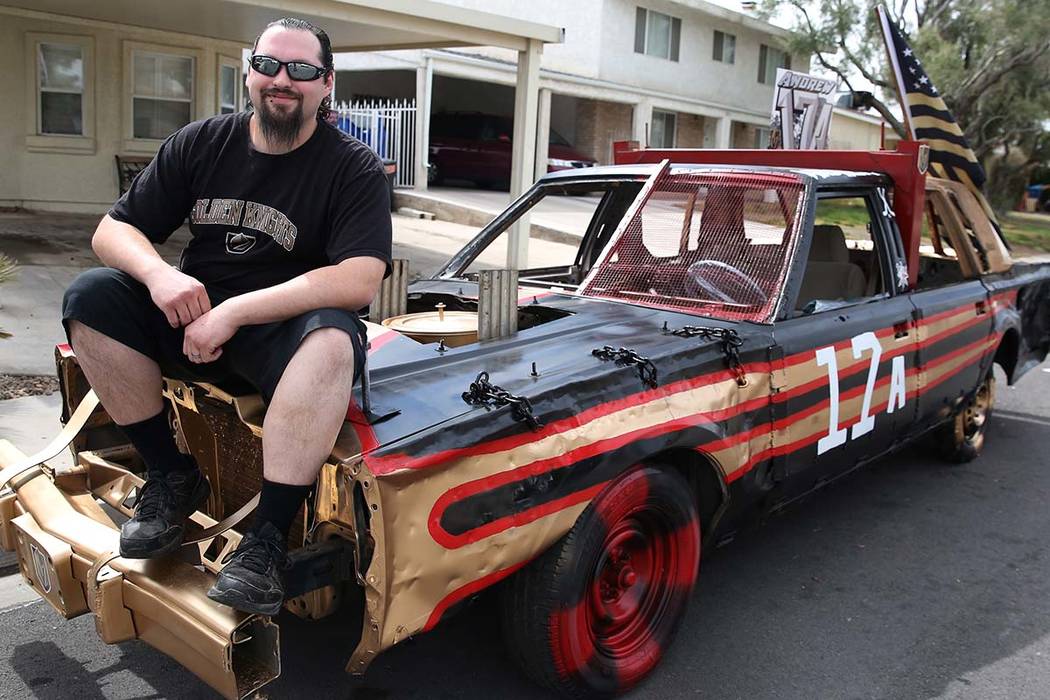 Andrew Carmean, a demolition driver, poses for a photo on his 1988 Lincoln Town Car on Tuesday, ...