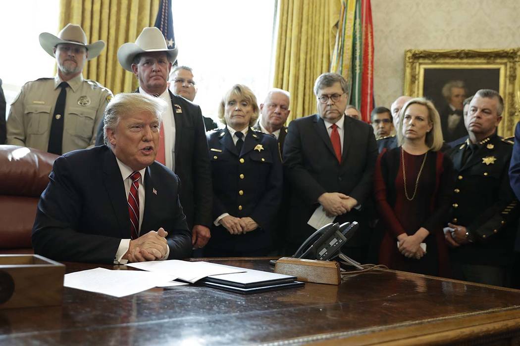 President Donald Trump speaks about border security in the Oval Office of the White House, Friday, March 15, 2019, in Washington, as Homeland Security Secretary Kirstjen Nielsen, second from right ...