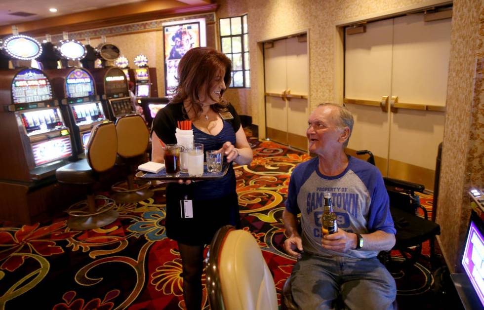 Robert Hansen of Las Vegas gets a drink from server, Ginger Glass-Trotter at Sam's Town Monday, ...