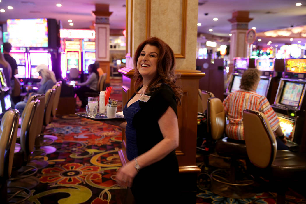 Twenty-five year cocktail server Ginger Glass-Trotter smiles at a customer at Sam's Town Monday ...