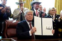 President Donald Trump issued the first veto of his presidency, overruling Congress to protect his emergency declaration for border wall funding, in the Oval Office of the White House, March 15, 2 ...