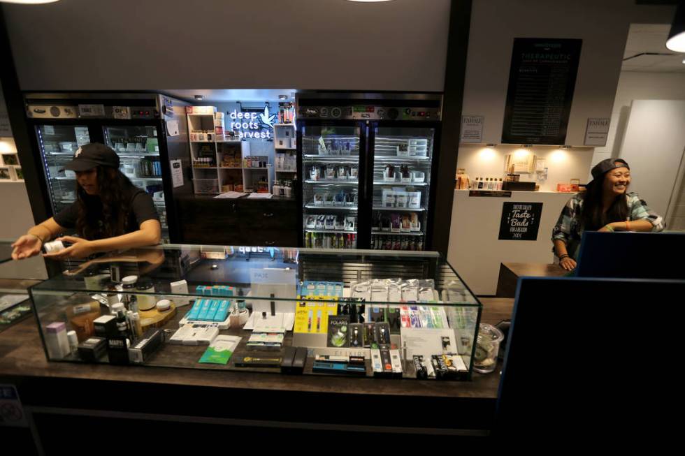 Alyssa Jusino, left, and Jezrey Saenz help customers at Exhale Nevada marijuana dispensary in Las Vegas Thursday, June 28, 2018. K.M. Cannon Las Vegas Review-Journal @KMCannonPhoto