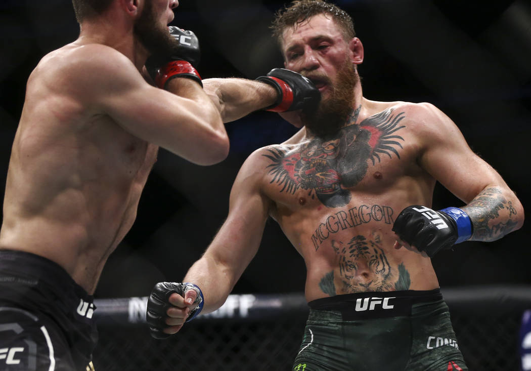 Conor McGregor, right, takes hits from Khabib Nurmagomedov during their lightweight title bout at UFC 229 at T-Mobile Arena in Las Vegas on Saturday, Oct. 6, 2018. Chase Stevens Las Vegas Review-J ...