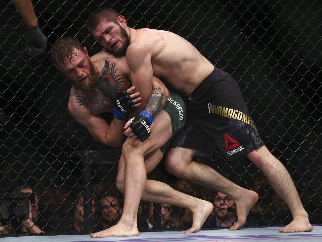 Khabib Nurmagomedov brings Conor McGregor to the mat during their lightweight title bout at UFC 229 at T-Mobile Arena in Las Vegas on Saturday, Oct. 6, 2018. Chase Stevens Las Vegas Review-Journal ...