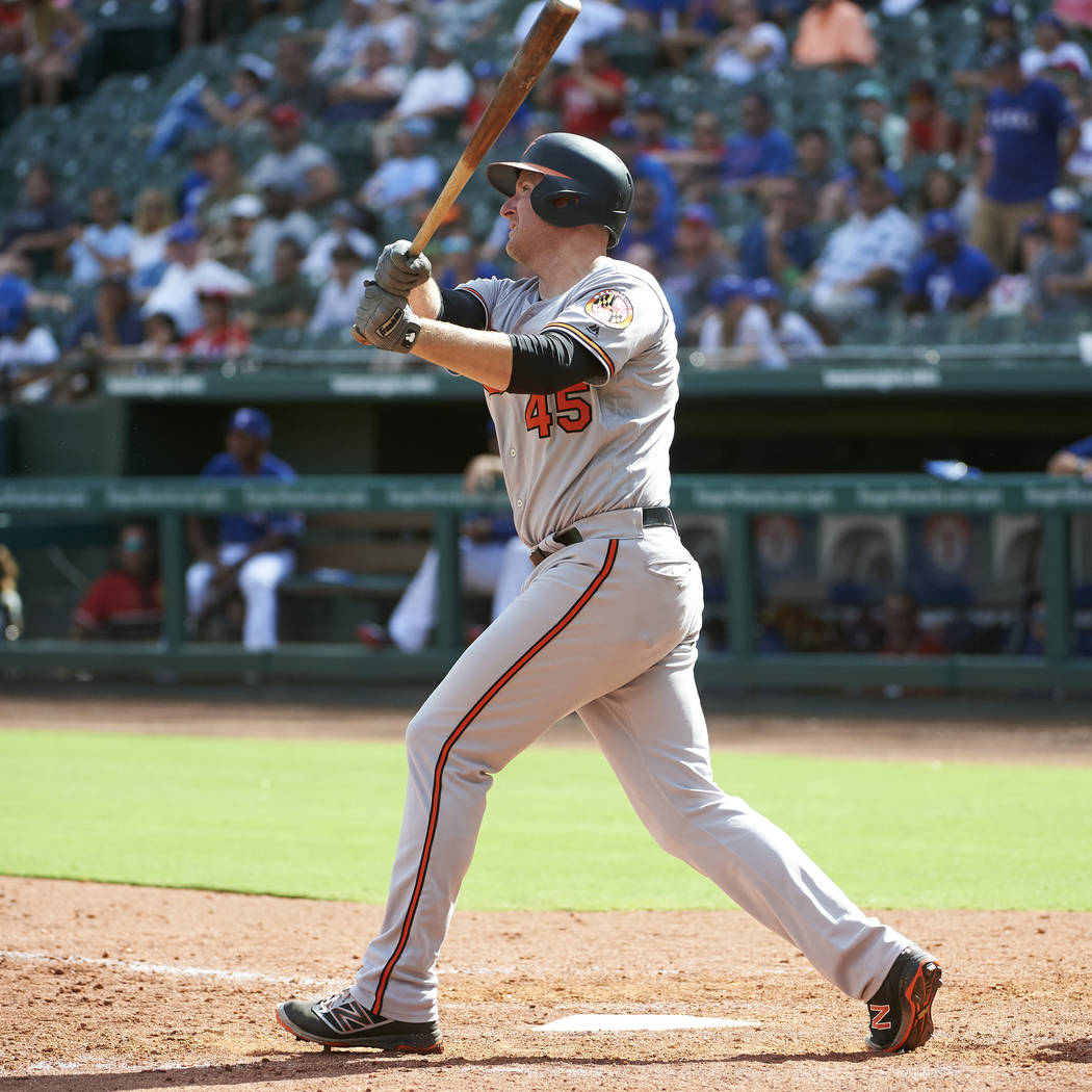 Baltimore Orioles' Mark Trumbo hits a two-run home run against the Texas Rangers during the seventh inning of a baseball game in Arlington, Texas, Sunday, Aug. 5, 2018. (AP Photo/Cooper Neill)