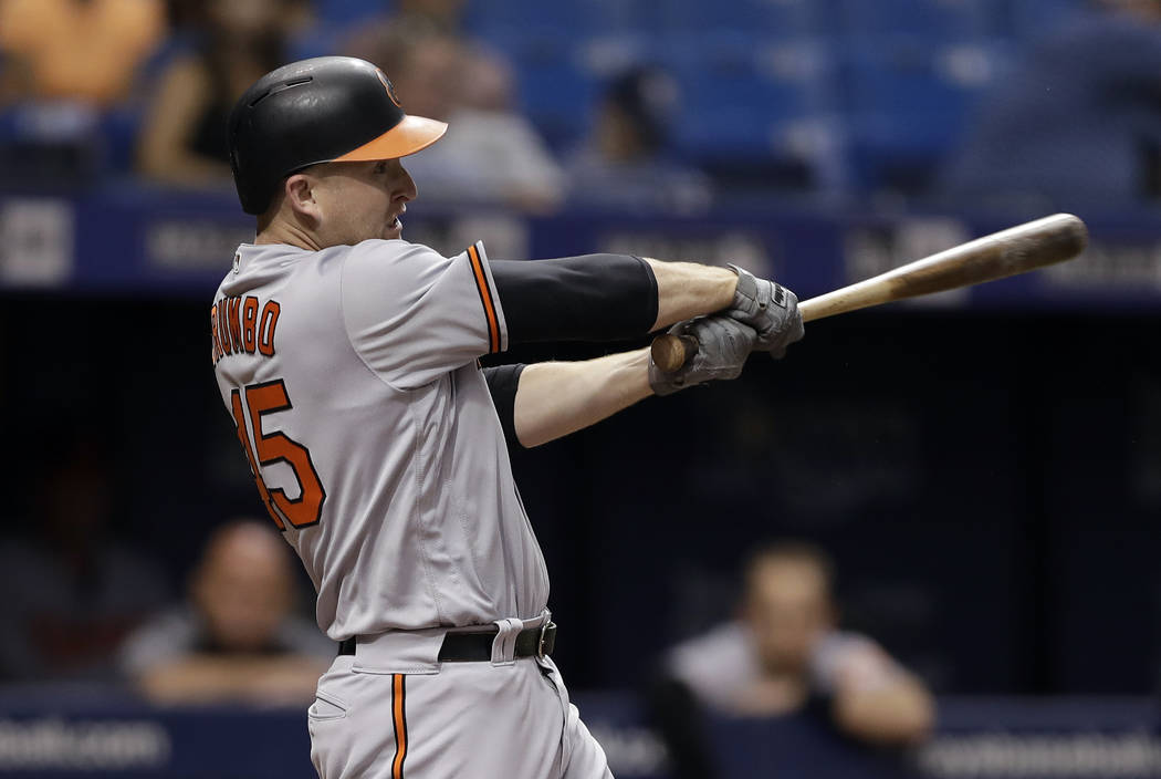 FILE - In this Aug. 7, 2018, file photo, Baltimore Orioles' Mark Trumbo swings for an RBI single against the Tampa Bay Rays during the sixth inning of a baseball game, in St. Petersburg, Fla. Slug ...
