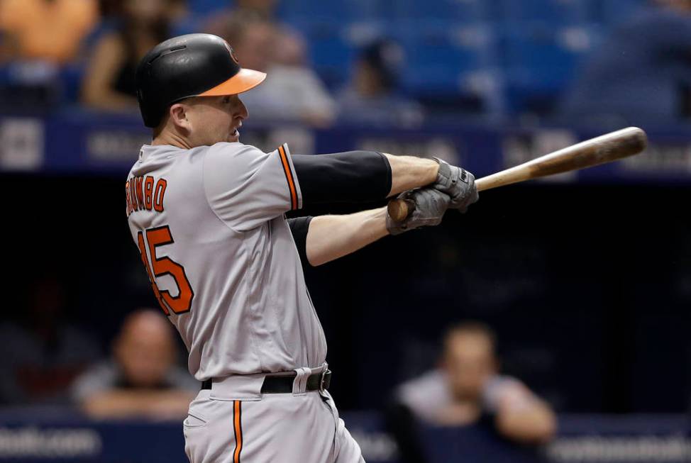 FILE - In this Aug. 7, 2018, file photo, Baltimore Orioles' Mark Trumbo swings for an RBI single against the Tampa Bay Rays during the sixth inning of a baseball game, in St. Petersburg, Fla. Slug ...