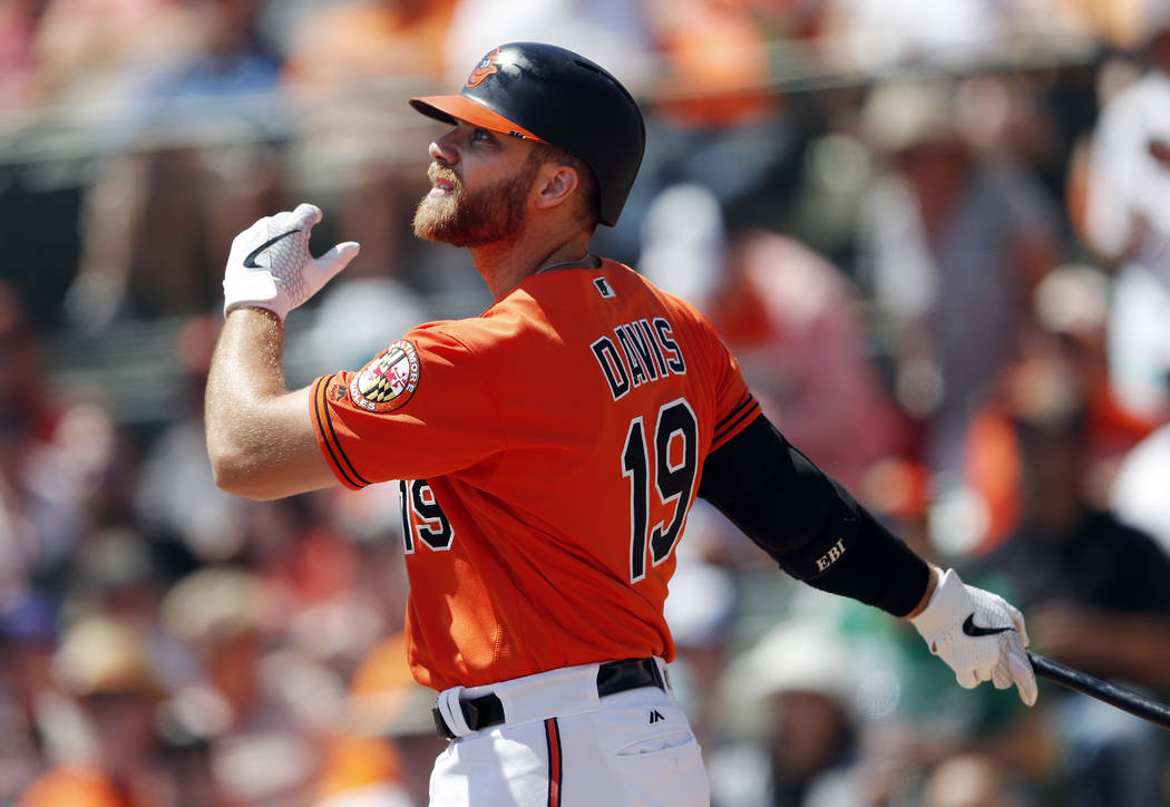 Baltimore Orioles first baseman Chris Davis (19) follows through on a home run in the first inning of a spring training baseball game against the New York Mets Monday, March 25, 2019, in Sarasota, ...