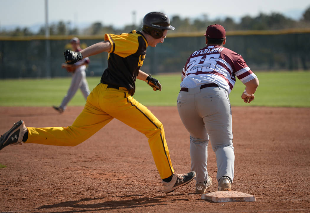 Cimarron-Memorial infielder Mike Overland (25) catches the ball getting out Bonanza first baseman Ryan Webster (19) runs to first base during a baseball game at Bonanza High School in Las Vegas, T ...