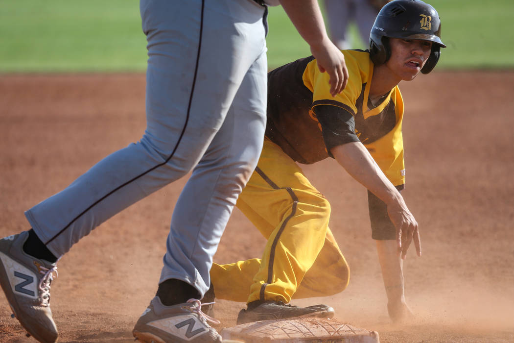 Bonanza second baseman Julian DeLeon (3) slides safely into first base during a baseball game against Cimarron-Memorial High School at Bonanza High School in Las Vegas, Tuesday, March 26, 2019. (C ...