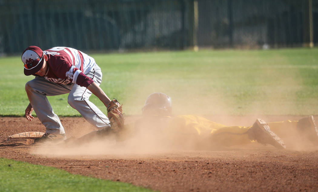 Cimarron-Memorial infielder Andrew Johnson (3) tags Bonanza second baseman Julian DeLeon (3) as he slides safely into second base during a baseball game at Bonanza High School in Las Vegas, Tuesda ...