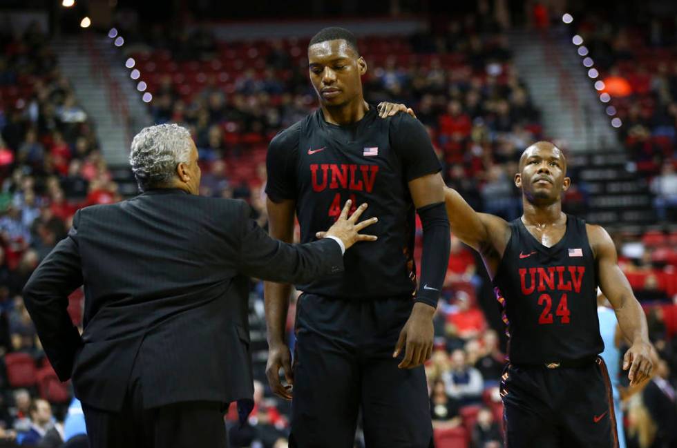 UNLV Rebels guard Jordan Johnson (24) comforts UNLV Rebels forward Brandon McCoy (44) as he returns to the bench after drawing a technical foul during a basketball game at Thomas & Mack Center in ...