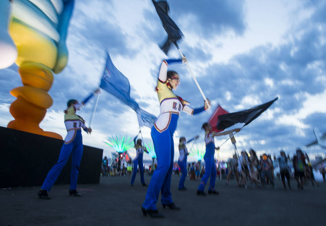 Costumed performers entertain attendees during the third day of the Electric Daisy Carnival at ...