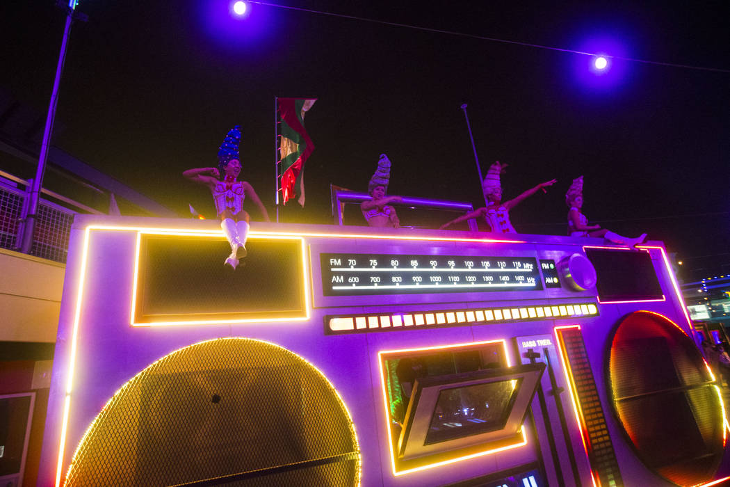 Costumed performers dance at the Boombox art car in Carnival Square during the third day of the ...